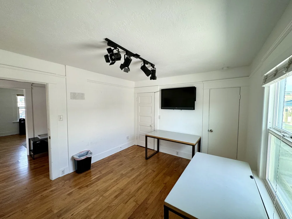 Empty private office with white walls and hardwood floors