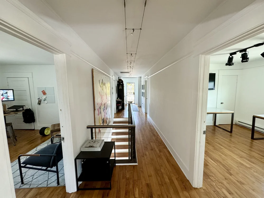 Hallway with white walls and wooden floors