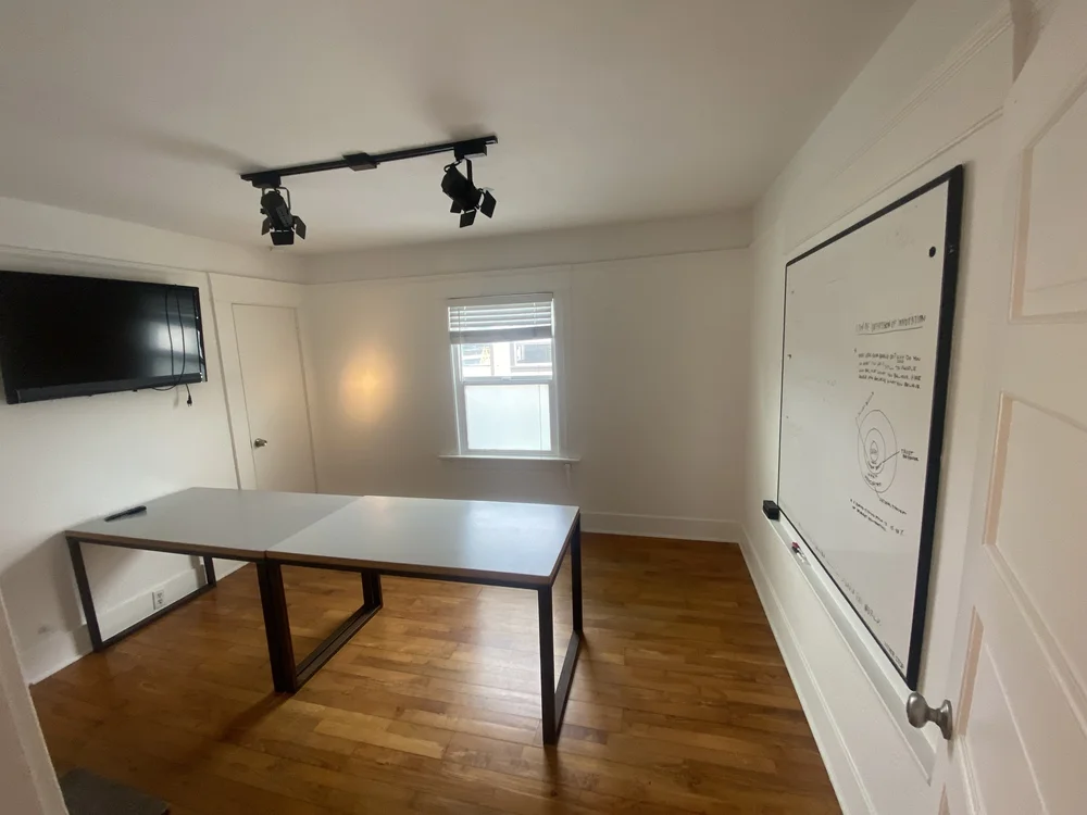 Office with a whiteboard on the wall, ready for a dedicated desk