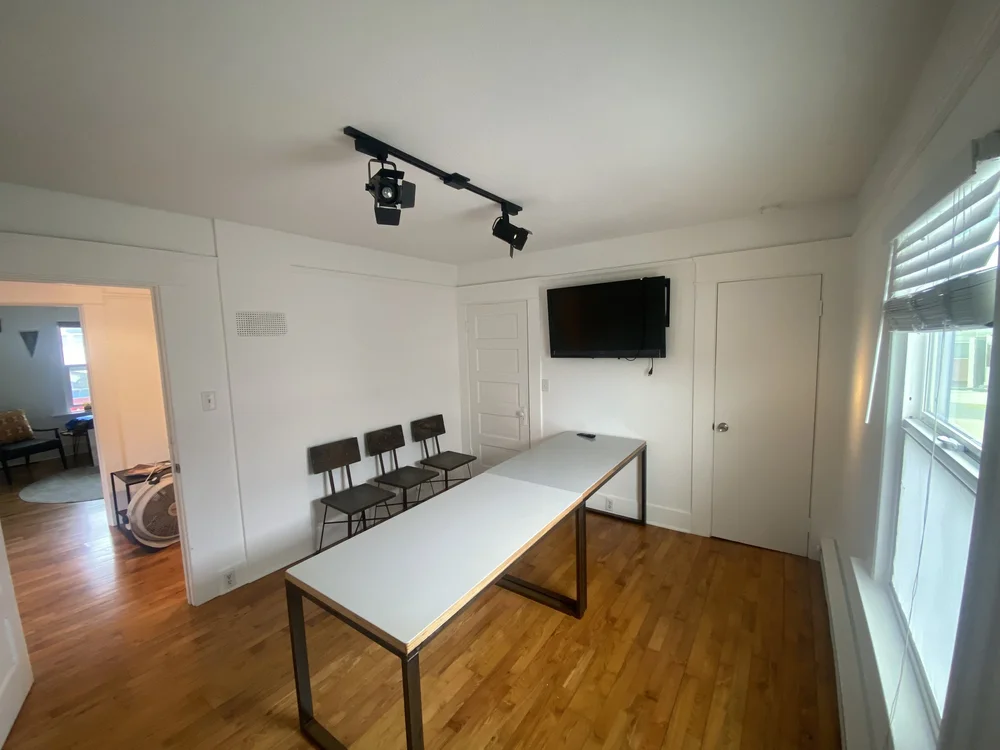 Conference room with a long white table and chairs